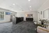 Modern office space with sleek reception desk, large windows overlooking a pool, and contemporary seating area.