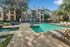 Luxurious apartment complex with a sparkling pool, surrounded by elegant architecture and lush greenery, offering ultimate relaxation and style.