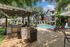 Elegant apartment courtyard featuring a sparkling pool, comfortable loungers, shaded BBQ area, and lush greenery.