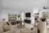 Modern open-concept living space with plush beige sofas, stylish round coffee table, elegant dining area, and contemporary kitchen, perfect for comfortable urban living.