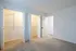 Modern bedroom with plush carpet and two spacious closets, offering ample storage and sleek design.