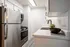 Modern kitchen with sleek stainless steel appliances, pristine countertops, and stylish cabinetry, creating an inviting culinary space.