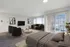 Modern apartment showcasing a bright and spacious open-plan living area with a cozy sofa, chic decor, and large windows with blinds, offering ample natural light.