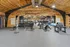 Luxurious wooden-accented fitness center with modern gym equipment and spacious workout area offering a premium exercise experience.