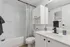 Modern bathroom with sleek fixtures, bright white cabinetry, and a stylish countertop for an inviting and functional space.