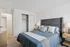 Inviting bedroom with elegant decor, featuring a plush bed, modern headboard, and soft lighting perfect for relaxation.