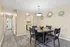 Chic dining area with elegant decor, polished wood floors, and stylish lighting creating a sophisticated ambiance.