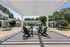 Charming outdoor area featuring a stylish pergola, inviting pool, and comfortable seating arrangements, ideal for relaxation and leisure.