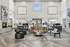 Inviting apartment lobby with modern seating, chic fireplace, and abundant natural light.