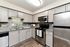 Modern kitchen with sleek stainless steel appliances, elegant gray cabinetry, and a stylish backsplash. Bright and inviting, perfect for culinary creativity.
