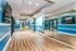 Modern fitness room with vibrant blue accents, featuring exercise bikes and colorful stability balls, creating an energizing workout environment.