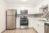 Modern kitchen with sleek stainless steel appliances, elegant white cabinetry, and a stylish tiled backsplash.