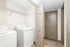 Modern laundry room featuring a sleek washer and dryer with ample shelving for convenient storage.