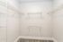 Spacious walk-in closet with wire shelving, perfect for organized storage solutions.