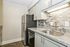Modern kitchen with sleek stainless steel appliances, granite countertops, and elegant tile backsplash.