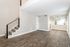 Bright, open-concept living area featuring elegant hardwood floors and contemporary finishes, accentuated by natural light.