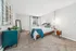 Inviting bedroom with a stylish modern design, showcasing a comfortable bed, elegant side tables, and cozy carpeted flooring.