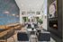 Inviting lounge area with modern decor, featuring a cozy fireplace, stylish seating, and abundant natural light from large windows.