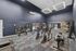 Modern fitness center with state-of-the-art gym equipment, high ceilings, and elegant lighting.