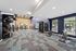 Modern fitness center with state-of-the-art exercise equipment, featuring a serene ambiance and large windows for natural light.