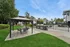 Inviting outdoor area featuring a stylish gazebo, modern grill station, and refreshing community pool, perfect for relaxation and entertaining.