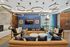 Luxurious living room adorned with elegant circular pendant lights, plush sofas, and vibrant decor, offering a sophisticated ambiance.