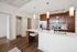 Modern kitchen with sleek cabinetry, stainless steel appliances, and elegant pendant lighting, offering a luxurious and functional cooking space.