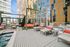 Luxurious rooftop terrace with stylish lounge chairs, vibrant cushioned seating, and modern cityscape views.