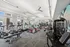 Spacious and modern fitness center with cutting-edge equipment, ample natural light, and stylish design.