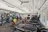 Modern fitness center equipped with state-of-the-art treadmills, weightlifting stations, and vibrant exercise balls, offering a bright and energizing workout environment.
