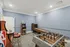 Vibrant entertainment room featuring classic arcade games, foosball, and basketball shooter, perfect for leisurely fun.