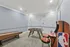 Stylish recreation room featuring a foosball table, arcade game, and shuffleboard, with modern design and playful aesthetics.