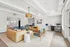 Bright and modern living space featuring cozy seating, stylish decor, and a functional workspace with a computer.