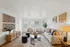 Bright and inviting living room with modern decor, featuring a cozy sofa, stylish armchairs, and tasteful wall art.