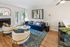 Contemporary living room with plush seating, vibrant decor, and a cozy fireplace, ideal for relaxation and style.