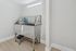 Bright and modern utility room featuring a sleek stainless steel sink with convenient storage solutions, ideal for efficient living.