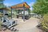 Inviting outdoor patio with stylish pergola, modern grill station, and cozy fireplace, perfect for entertaining and relaxation.