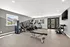 Bright and modern home gym featuring state-of-the-art fitness equipment, sleek treadmill, adjustable dumbbells, and scenic window views.