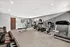 Modern fitness center equipped with treadmills, exercise bikes, and free weights, offering a bright and welcoming workout space.