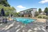 Inviting outdoor pool area with stylish lounge chairs and shaded seating, perfect for relaxation and entertaining.