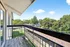 Inviting balcony with charming views of lush greenery, perfect for relaxation and enjoying serene surroundings.