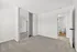 Bright and spacious bedroom with plush carpet, mirrored closet doors, and access to a modern bathroom.