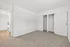 Bright bedroom featuring cozy carpeting and spacious closets, perfect for modern living.
