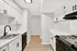 Bright and modern kitchen with sleek white cabinetry, stainless steel appliances, and elegant hardwood flooring.