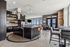 Chic and modern open-concept kitchen with sleek black cabinetry, spacious island, and panoramic city views.