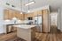 Modern kitchen with sleek stainless steel appliances, elegant wooden cabinetry, and a spacious island under stylish pendant lighting.