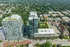 Aerial view of modern high-rise apartment buildings surrounded by lush greenery and a vibrant urban landscape.