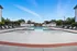 Inviting outdoor swimming pool with modern lounge chairs under a clear blue sky, perfect for relaxation and enjoyment.