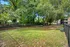 Lush green outdoor area with benches and a fenced boundary, perfect for relaxation and enjoying nature.