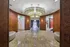 Elegant lobby with luxurious lighting, polished marble floors, and stylish wooden accents.